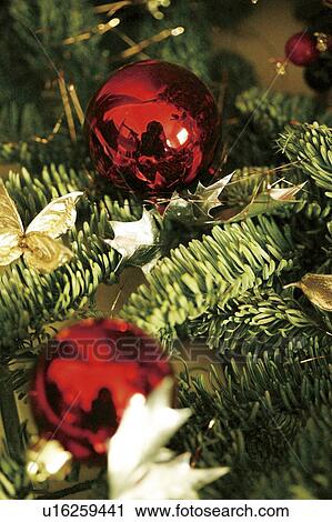 Stock Image - Close-up of baubles in a Christmas tree. Fotosearch