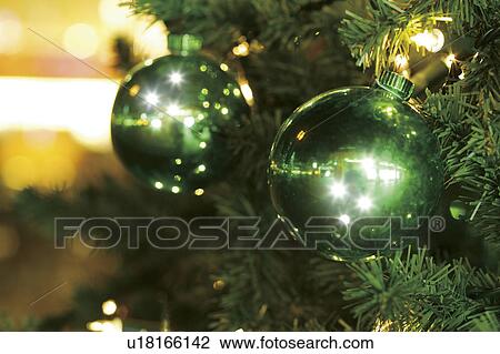 Stock Image - Close-up of baubles in a Christmas tree. Fotosearch