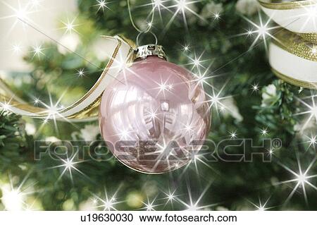 Stock Image - Close-up of baubles in a Christmas tree. Fotosearch