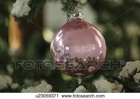 Stock Image - Close-up of baubles in a Christmas tree. Fotosearch