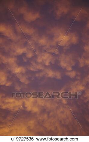 Stock Photograph - Clouds at sunset. Fotosearch