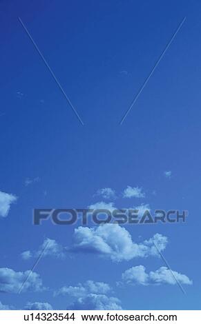 Clouds in a blue sky View Large Photo Image Picture - Clouds in a blue sky. Fotosearch