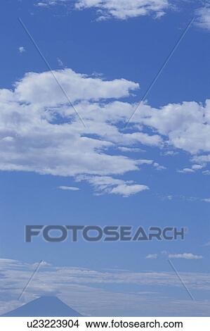Clouds in a blue sky View Large Photo Image Picture - Clouds in a blue sky. Fotosearch