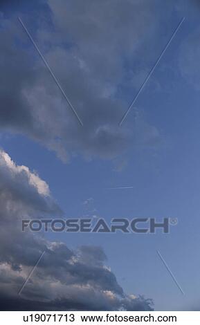 Clouds in a blue sky View Large Photo Image Stock Image - Clouds in a blue sky. Fotosearch