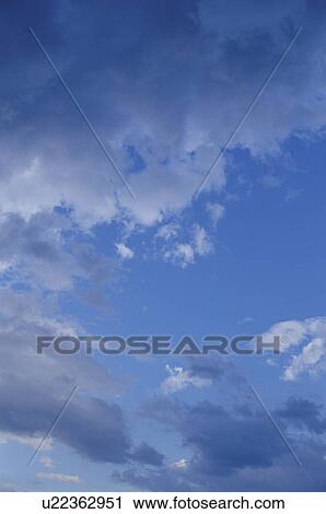 Clouds in a blue sky View Large Photo Image Stock Image - Clouds in a blue sky. Fotosearch