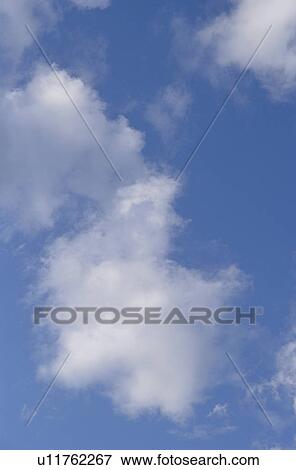 Clouds in a blue sky View Large Photo Image Stock Photo - Clouds in a blue sky. Fotosearch