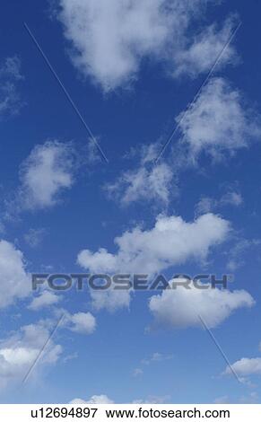 Clouds in a blue sky View Large Photo Image Stock Photo - Clouds in a blue sky. Fotosearch