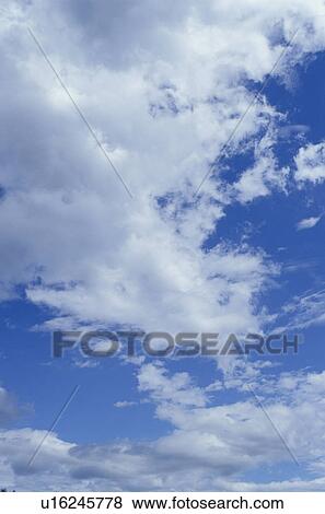 Clouds in a blue sky View Large Photo Image Stock Photo - Clouds in a blue sky. Fotosearch