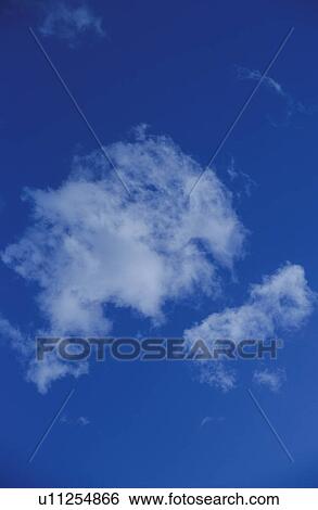 Clouds in a blue sky View Large Photo Image Stock Photograph - Clouds in a blue sky. Fotosearch