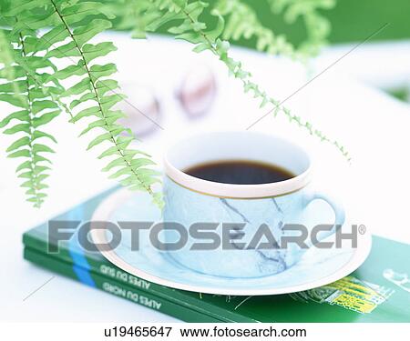 Coffee and books on an outdoor table View Large Photo Image Stock Photo - Coffee and books on an outdoor table. Fotosearch