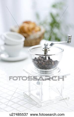 Stock Photo - Coffee beans in a coffee grinder. Fotosearch