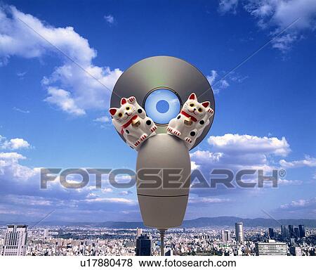 Stock Photo - Computer mouse, maneki nekos and cd above cityscape. Fotosearch