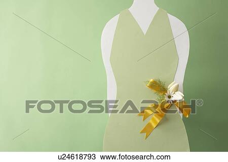 Stock Image - Corsage on green dress, green background. Fotosearch