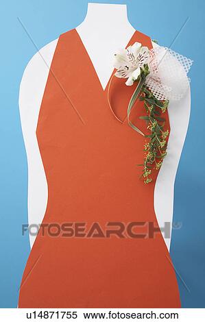 Stock Photography - Corsage on red dress, blue background. Fotosearch