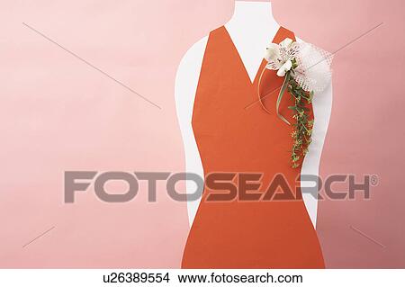 Picture - Corsage on red dress, pink background. Fotosearch