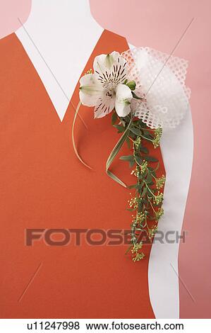 Stock Photo - Corsage on red dress, pink background. Fotosearch