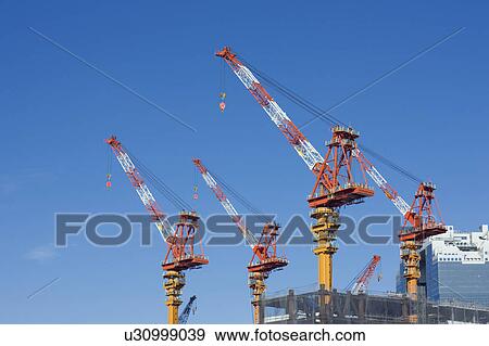 Stock Photo - Cranes at construction site. Kita-ku, Osaka, Japan. Fotosearch