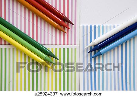 Stock Photo - Crayons on striped paper. Fotosearch