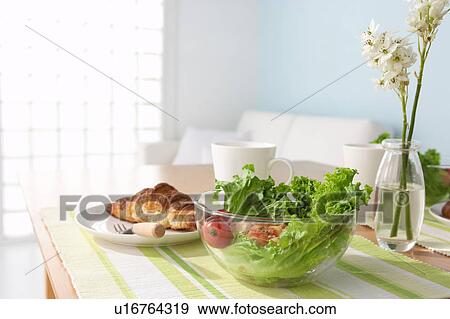 Stock Photo - Croissant with salad on table. Fotosearch