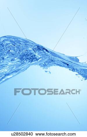 Stock Image - Cross section of water, close up, blue background, copy space. Fotosearch
