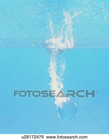 Stock Photo - Crystal ball falling into water. Fotosearch