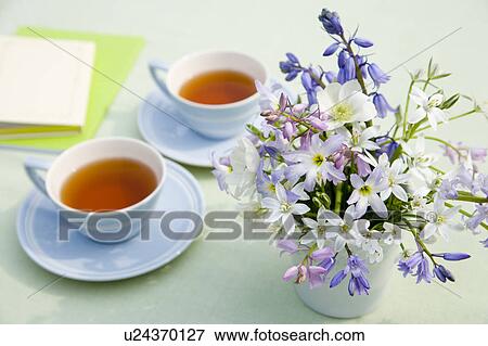 Stock Photo - Cups of tea and a vase of flowers. Fotosearch