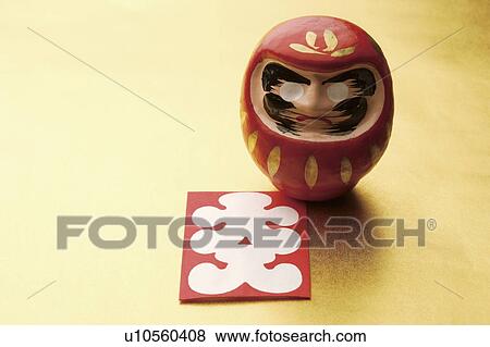 Stock Photo - Daruma doll and Japanese New Years playing card. Fotosearch