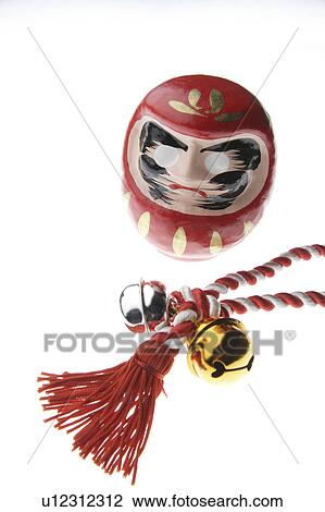 Stock Image - Daruma doll and rope with bells attached. Fotosearch