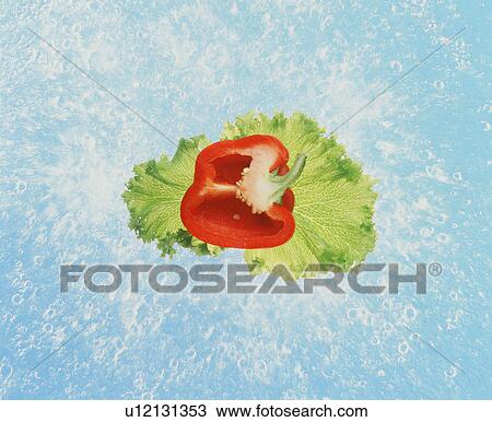 Stock Image - Digital composite of water splashing, lettuce and sliced red bell pepper. Fotosearch