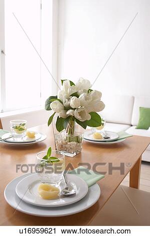 Stock Image - Dining table with plates and glasses. Fotosearch