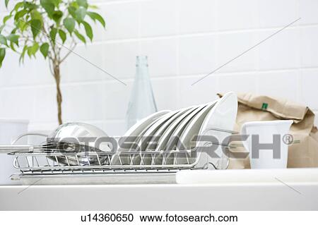 Stock Image - Dishes on a dish rack. Fotosearch