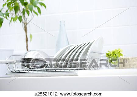 Stock Image - Dishes on a dish rack. Fotosearch