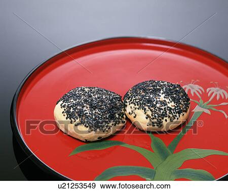 Dumplings seasoned with black sesame seeds on a tray View Large Photo Image Stock Photo - Dumplings seasoned with black sesame seeds on a tray. Fotosearch
