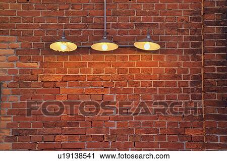 Stock Image - Electric lights and a brick wall. Fotosearch