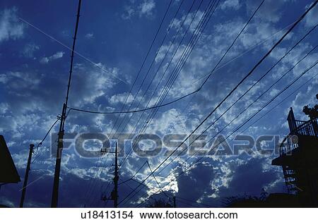 Electricity pylons under a cloudy twilight sky View Large Photo Image Picture - Electricity pylons under a cloudy twilight sky. Fotosearch
