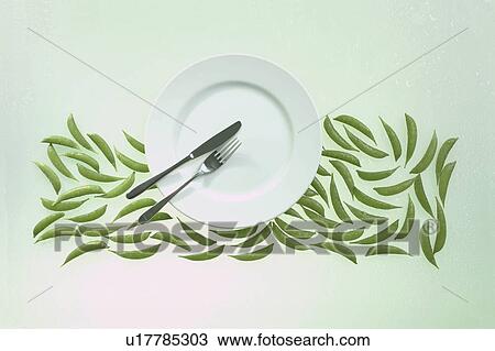 Stock Image - Empty plate above beans. Fotosearch