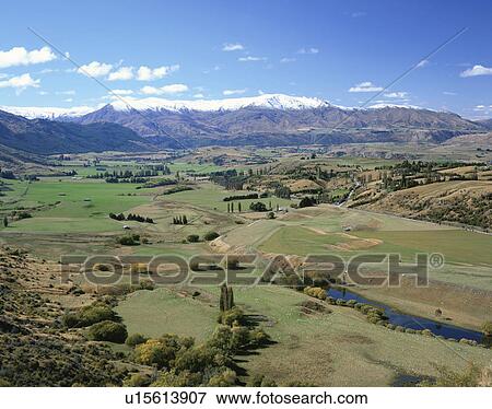 Farm landscape under mountain range. New Zealand View Large Photo Image Stock Photo - Farm landscape under mountain range. New Zealand. Fotosearch
