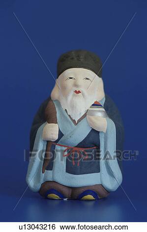 Stock Photograph - Figurine of Jurojin, one of the Japanese seven lucky Gods.. Fotosearch