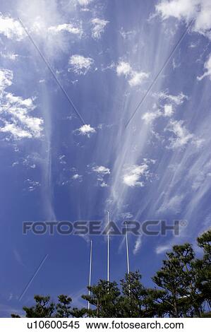 Stock Photography - Flagpoles under cirrus clouds. Yaita, Tochigi Prefecture, Japan. Fotosearch