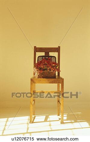 Stock Photography - Flower arrangement on wooden chair. Fotosearch
