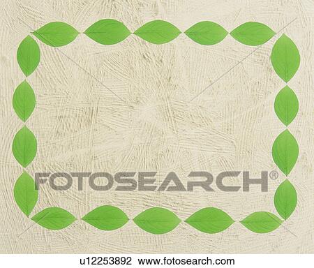 Stock Image - Frame made of leaves on a textured background. Fotosearch
