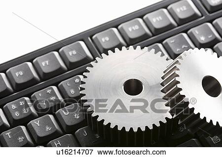 Stock Photo - Gears and computer keyboard. Fotosearch