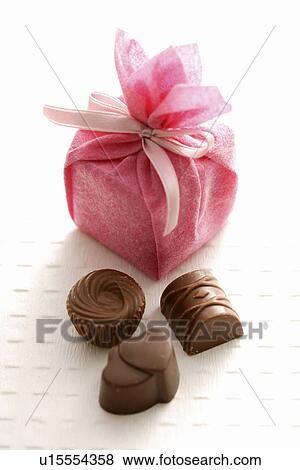 Gift box and chocolate pieces View Large Photo Image Stock Photo - Gift box and chocolate pieces. Fotosearch