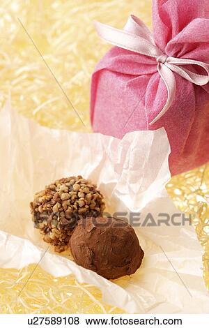 Stock Photo - Gift box and chocolate pieces. Fotosearch