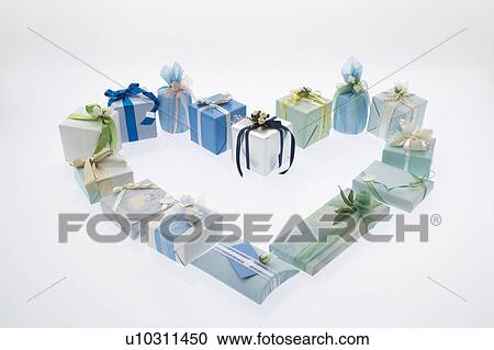 Stock Image - Gifts forming the shape of a heart.. Fotosearch