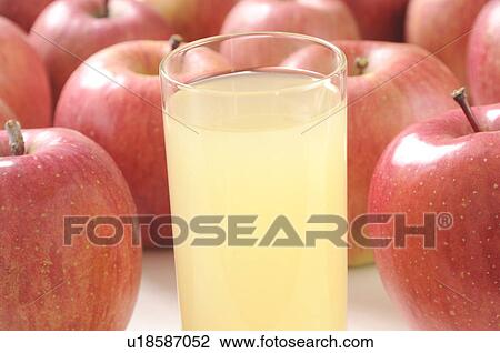 Glass of apple juice amongst apples View Large Photo Image Stock Image - Glass of apple juice amongst apples. Fotosearch