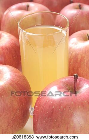 Stock Photo - Glass of apple juice amongst apples. Fotosearch