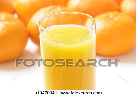 Glass of orange juice amongst oranges View Large Photo Image Stock Image - Glass of orange juice amongst oranges. Fotosearch