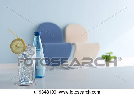 Glass of water and bottle on table View Large Photo Image Stock Photo - Glass of water and bottle on table. Fotosearch