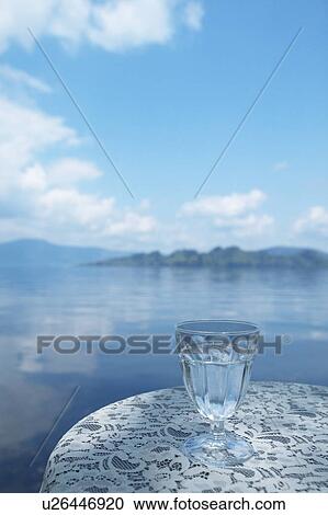 Glass of water on a table by a lake, Towada, Aomori Prefecture, Japan View Large Photo Image Stock Image - Glass of water on a table by a lake, Towada, Aomori Prefecture, Japan. Fotosearch